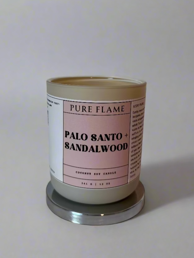Candle labeled 'Pure Flame' with 'Palo Santo & Sandalwood' on a white surface.