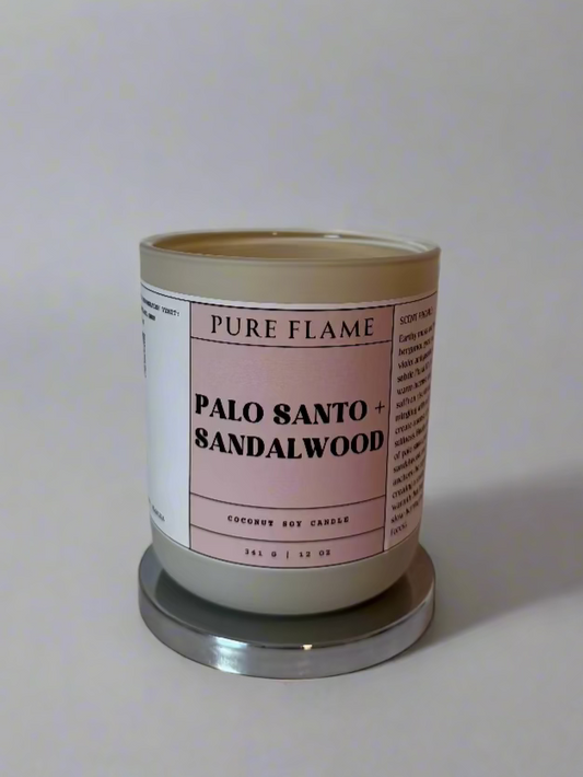 Candle labeled 'Pure Flame' with 'Palo Santo & Sandalwood' on a white surface.