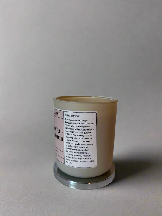 Pure Flame Palo Santo and Sandalwood Candle with a label on a white surface